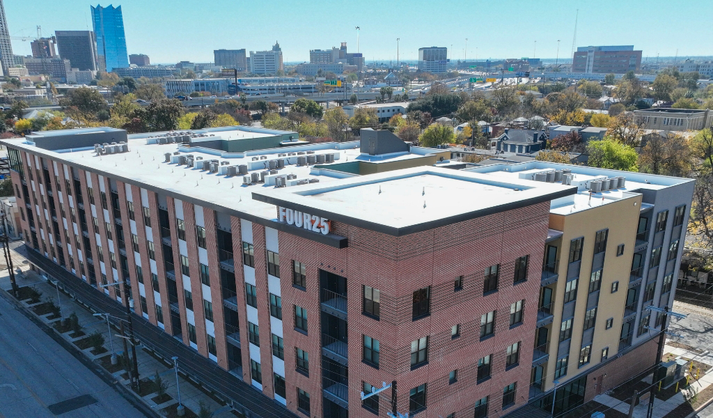 Aerial view of Four25 San Pedro housing complex, with the San Antonio skyline visible in the background.