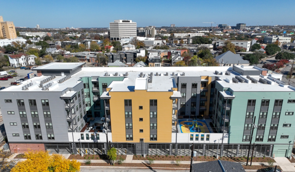 Drone view of the back side of Four25 San Pedro housing complex, with downtown San Antonio visible in the background.